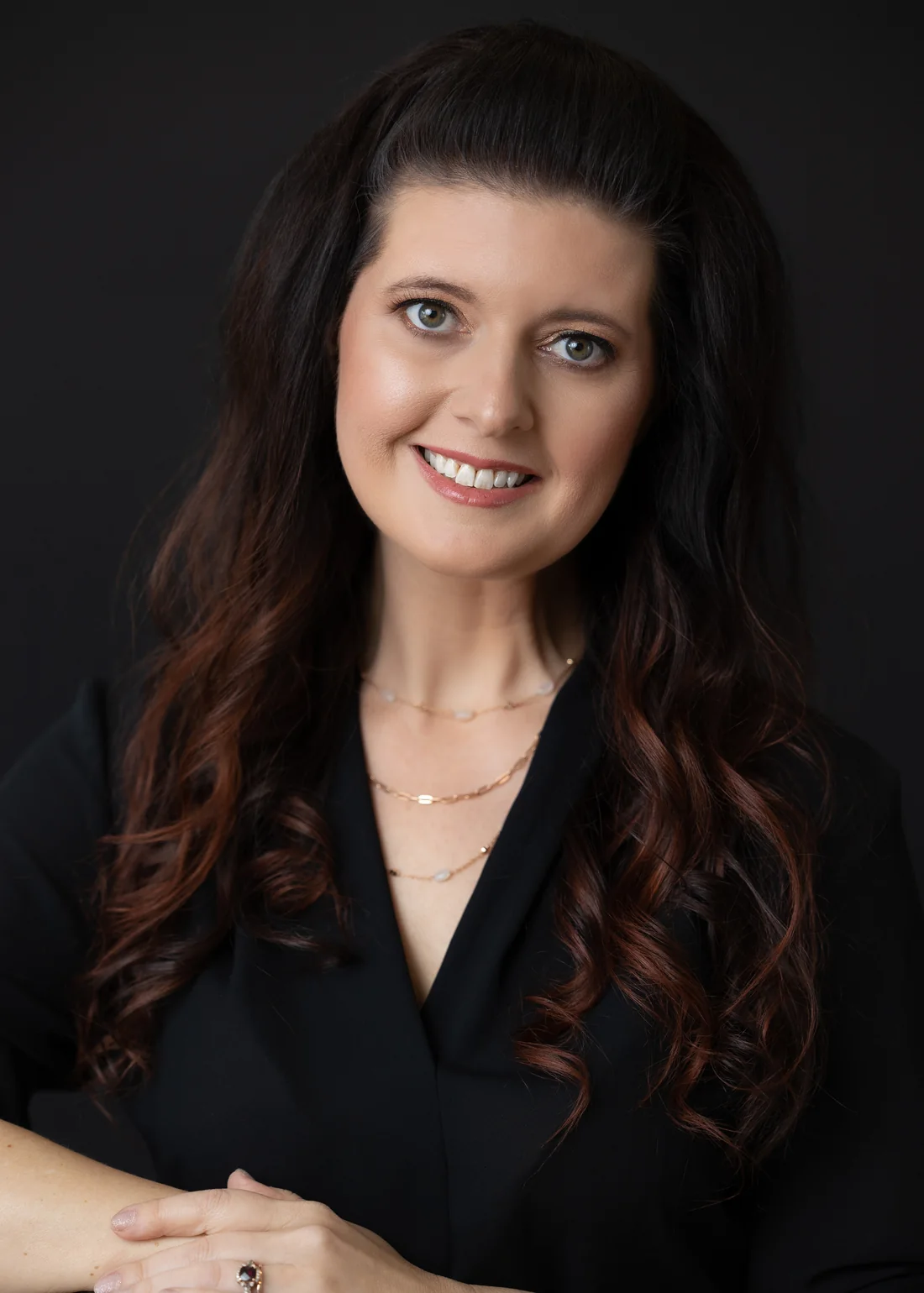 Erica Day, founder of ResetAway, smiling warmly against a dark background